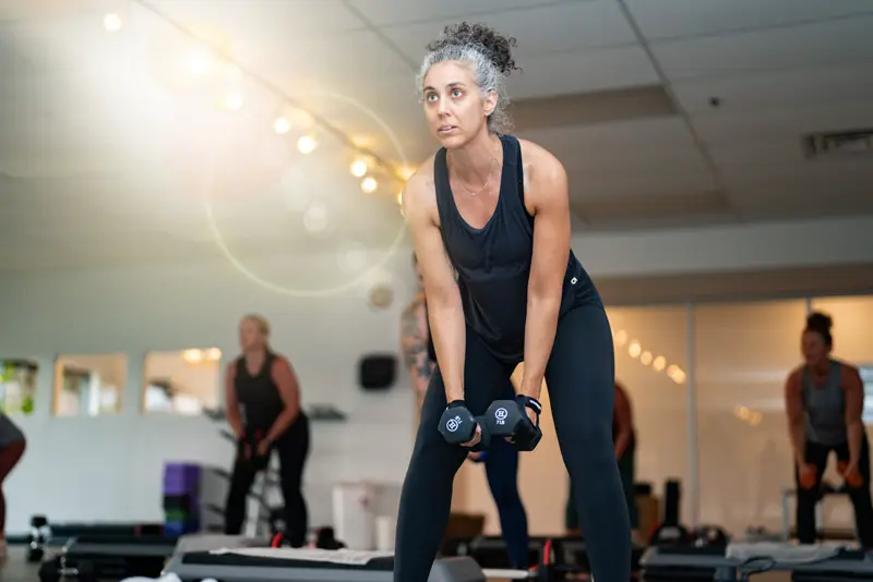 Woman lifting kettlebells during a personal training session